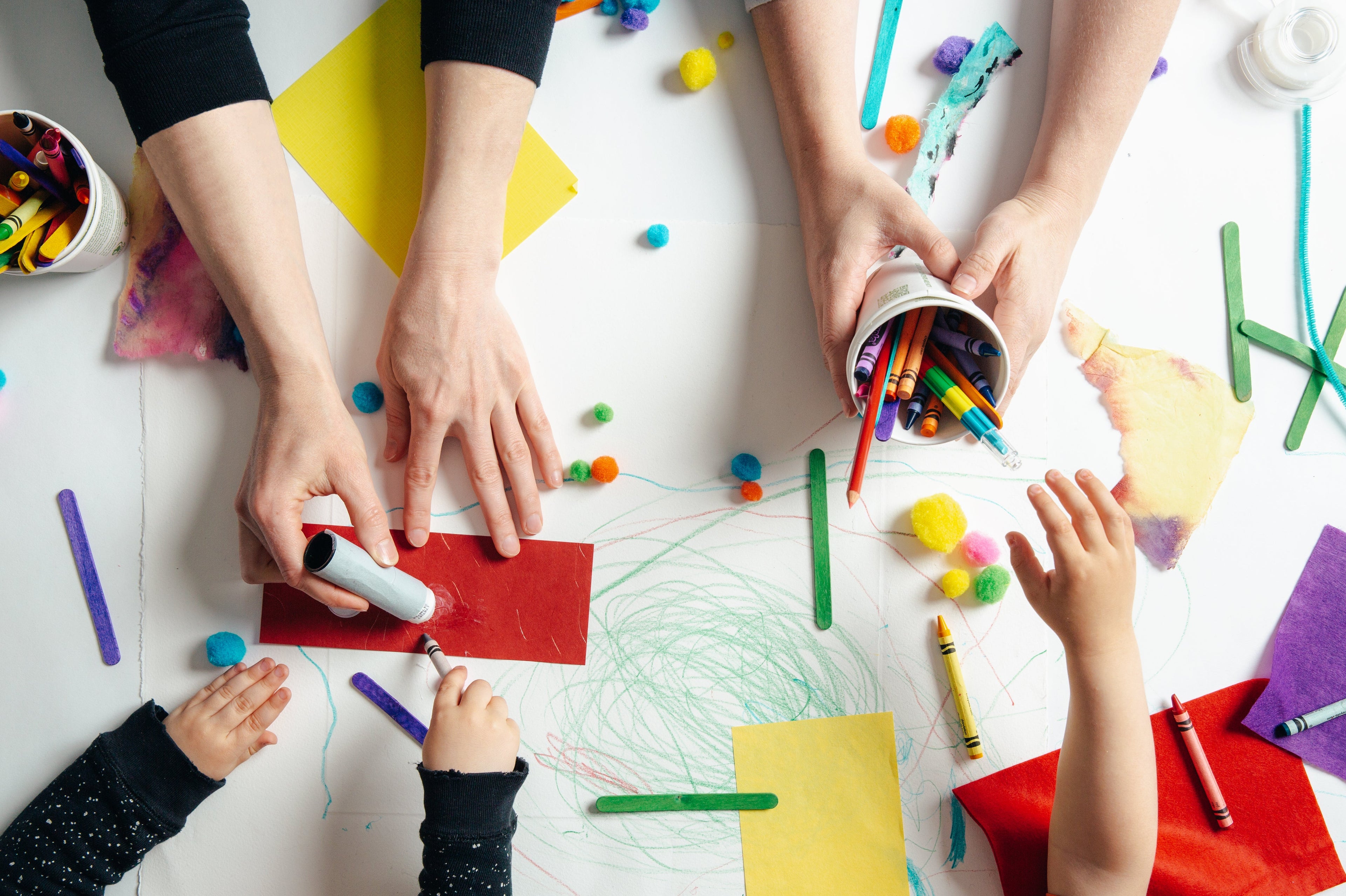 Early childhood educators and kids playing with crafts and activities