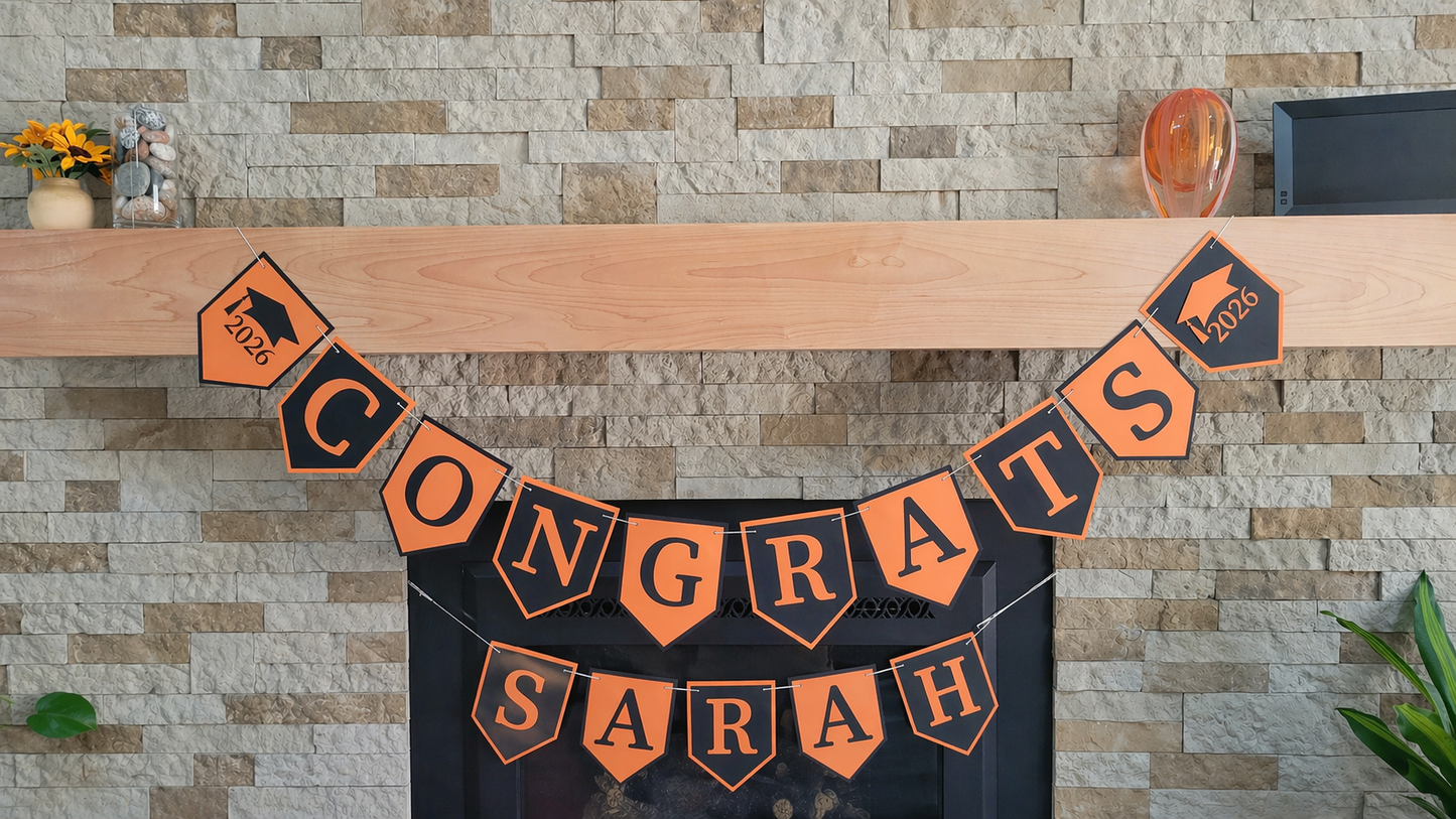 Personalized graduation 'CONGRATS' banner on a fireplace with graduation cap and year design